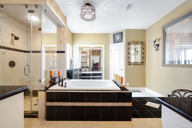 bathroom featuring vanity, separate shower and tub, and tile patterned floors