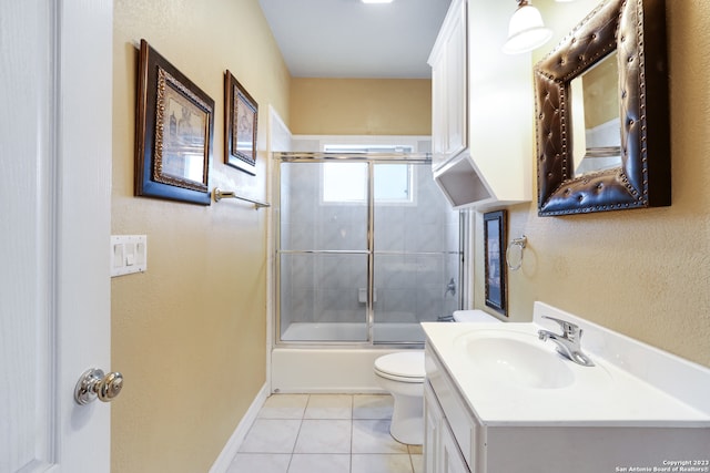 full bathroom with tile patterned floors, combined bath / shower with glass door, vanity, and toilet