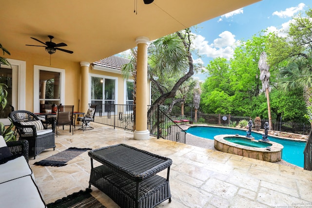 view of patio / terrace with ceiling fan and a pool with hot tub