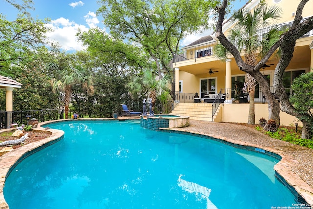 view of swimming pool with ceiling fan, a patio, and an in ground hot tub