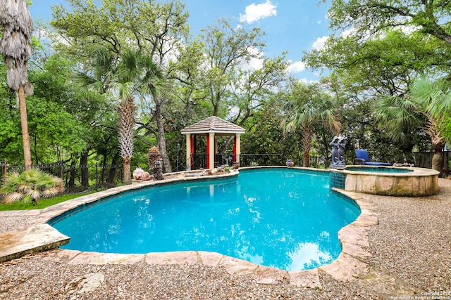 view of pool with an in ground hot tub and a gazebo