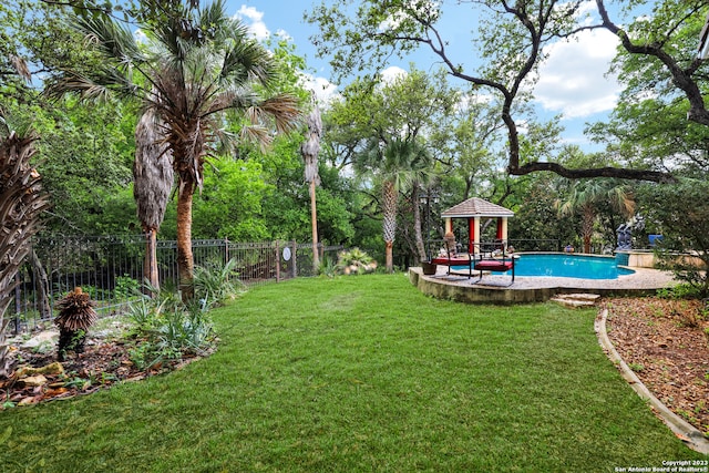 view of yard featuring a fenced in pool, a patio area, and a gazebo