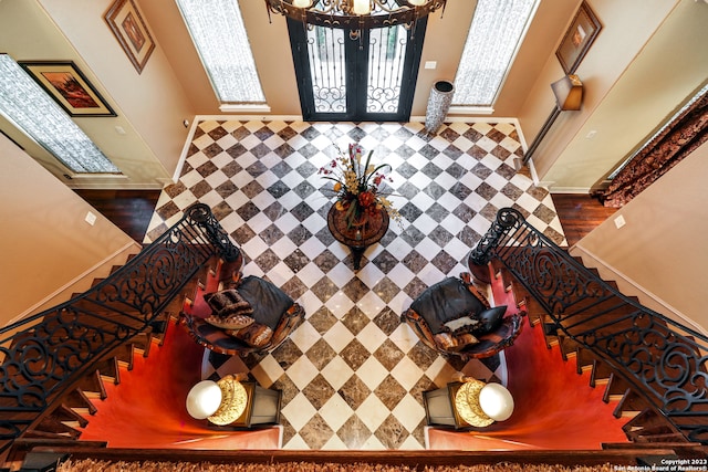 foyer entrance featuring wood-type flooring and an inviting chandelier