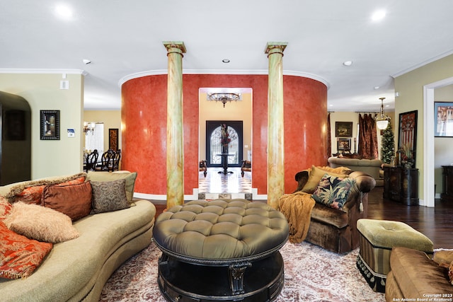 living room featuring wood-type flooring, decorative columns, and ornamental molding