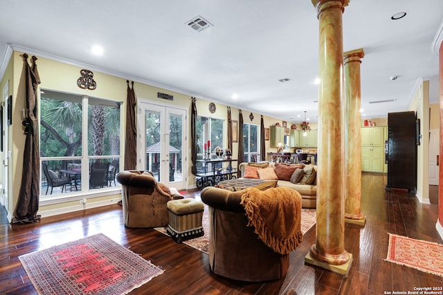 living room with dark wood-type flooring, crown molding, and ornate columns