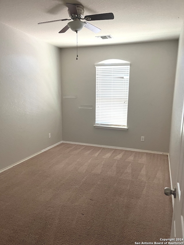 carpeted empty room with ceiling fan