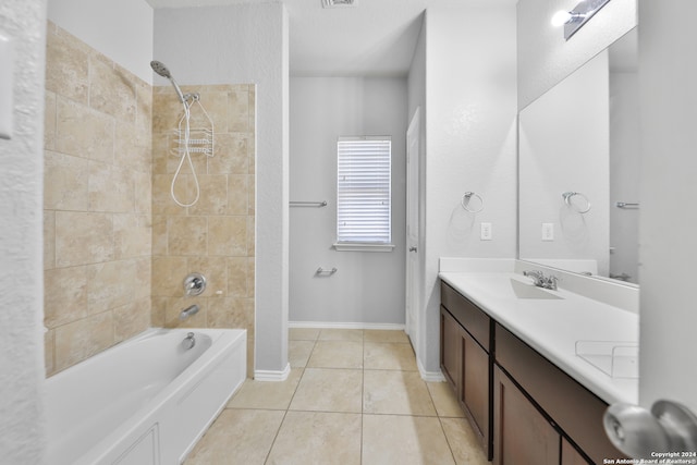 bathroom with vanity, tile patterned flooring, and tiled shower / bath