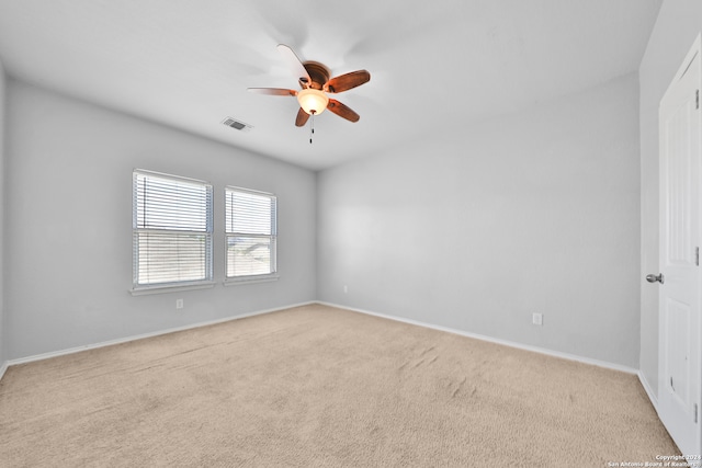 carpeted spare room featuring ceiling fan