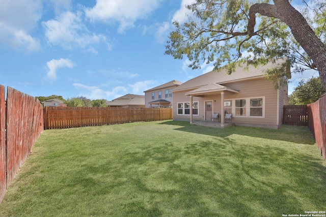 back of property featuring a yard and a patio area