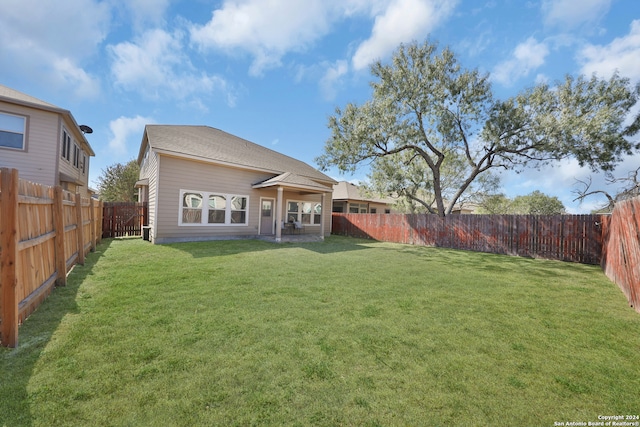 rear view of property with a lawn