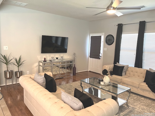 living room featuring ceiling fan and dark hardwood / wood-style flooring