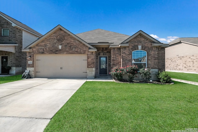 view of front facade with a garage and a front lawn