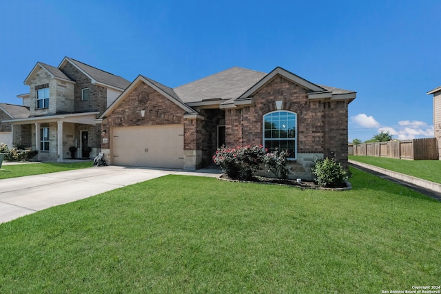 view of front of property featuring a front yard and a garage