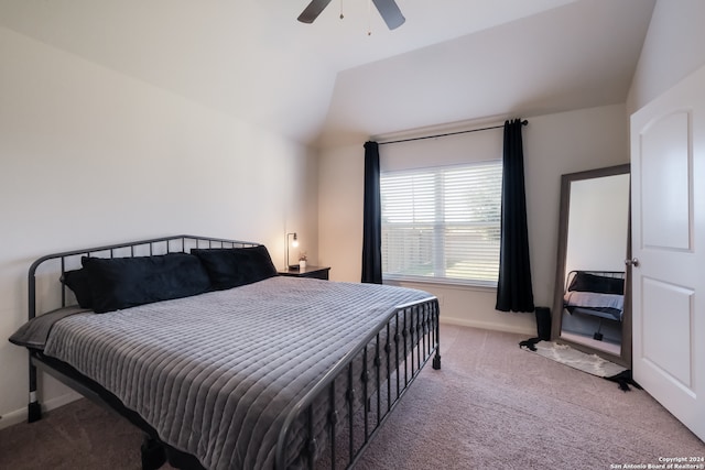 bedroom featuring light carpet, vaulted ceiling, and ceiling fan