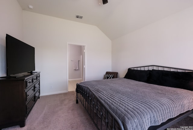 carpeted bedroom featuring connected bathroom and lofted ceiling