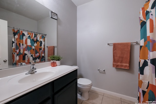 bathroom with vanity, toilet, and tile patterned floors