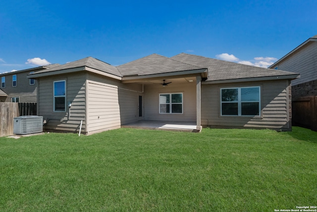 back of property featuring a yard, a patio, and central AC