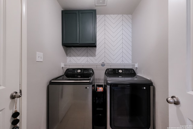 laundry area with cabinets and washer and dryer