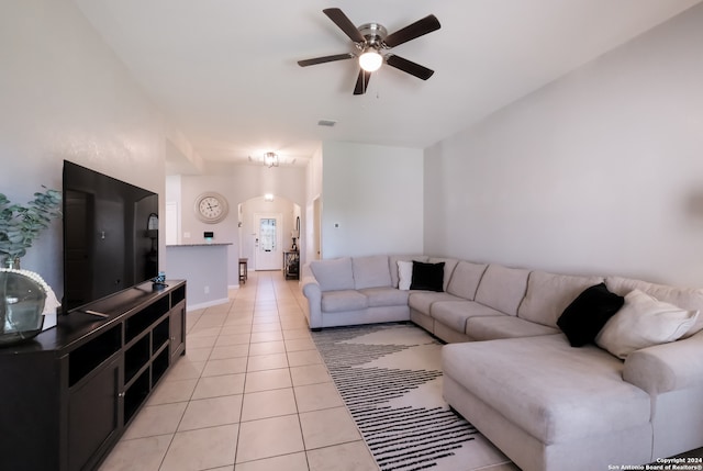 tiled living room with ceiling fan