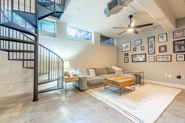 living room with concrete flooring, a towering ceiling, and ceiling fan