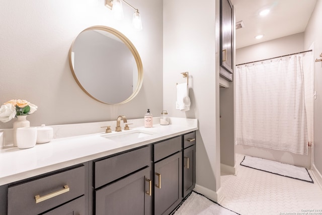 bathroom featuring walk in shower, vanity, and tile patterned floors