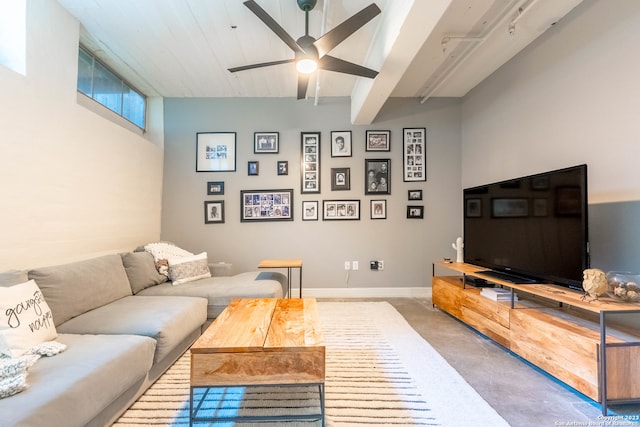 living room with ceiling fan and concrete floors