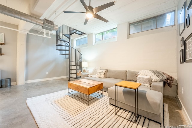 living room with a high ceiling and ceiling fan