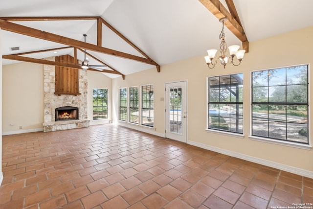 unfurnished living room with beamed ceiling, a stone fireplace, high vaulted ceiling, tile patterned floors, and ceiling fan with notable chandelier