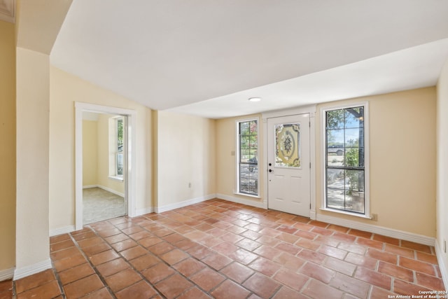 tiled entryway featuring lofted ceiling and plenty of natural light