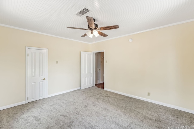 empty room with carpet, ceiling fan, and crown molding