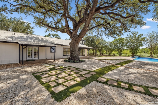 view of yard featuring french doors and a patio area