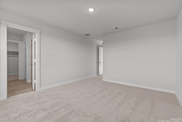 unfurnished room featuring light carpet