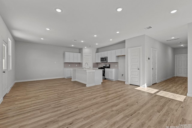 unfurnished living room with light wood-type flooring and sink