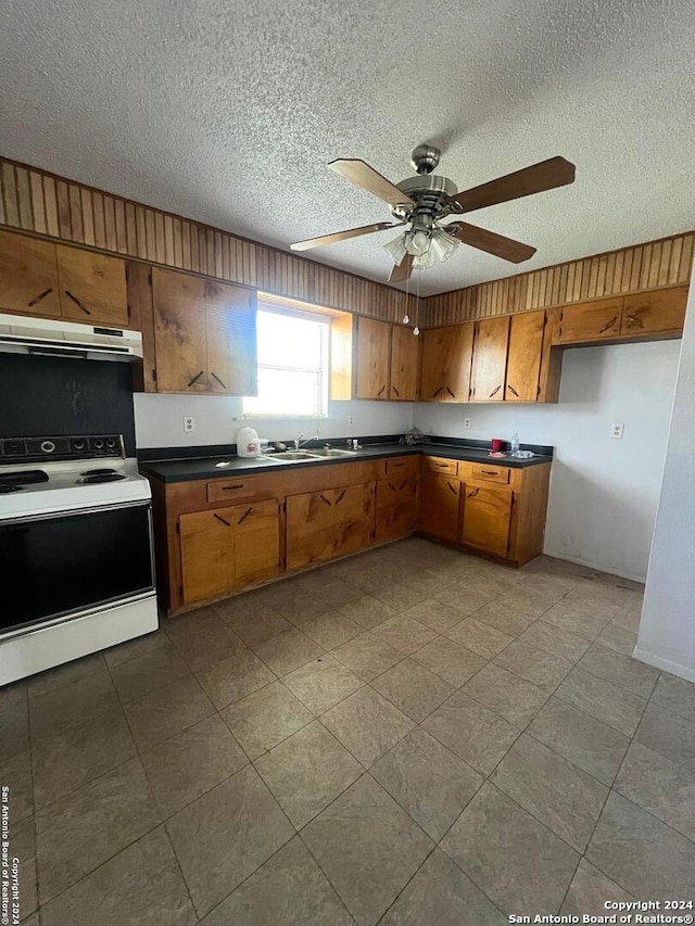 kitchen featuring ceiling fan, sink, white electric stove, and a textured ceiling