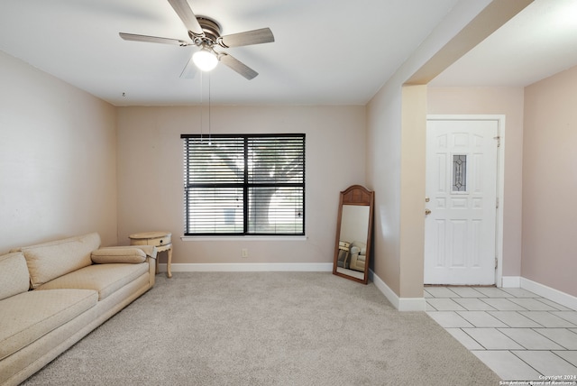 carpeted living room with ceiling fan