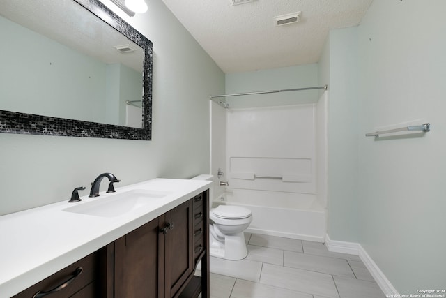 full bathroom with vanity, a textured ceiling, tile patterned flooring, toilet, and bathtub / shower combination