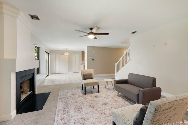 carpeted living room featuring ceiling fan