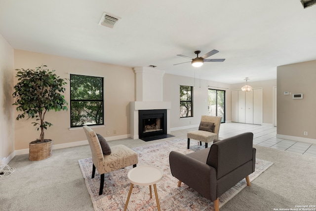 carpeted living room with ceiling fan