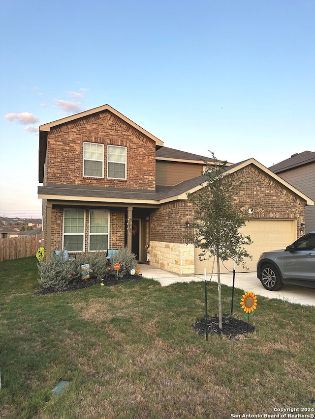 view of front property with a garage and a front yard