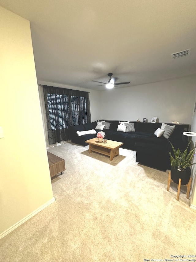 living room with ceiling fan and light colored carpet