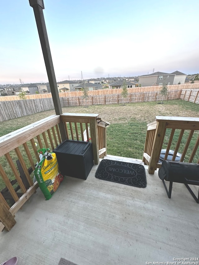 wooden deck featuring a lawn and a patio area