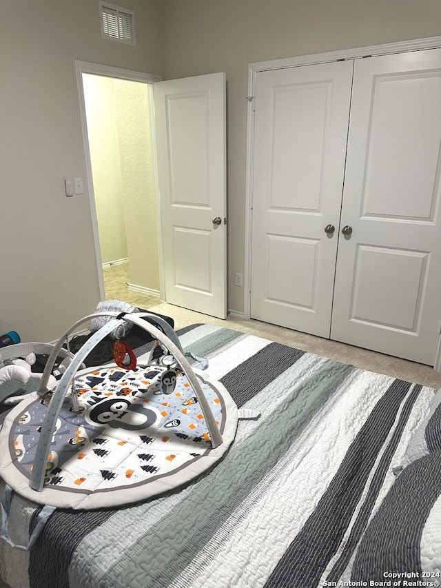 carpeted bedroom featuring a closet