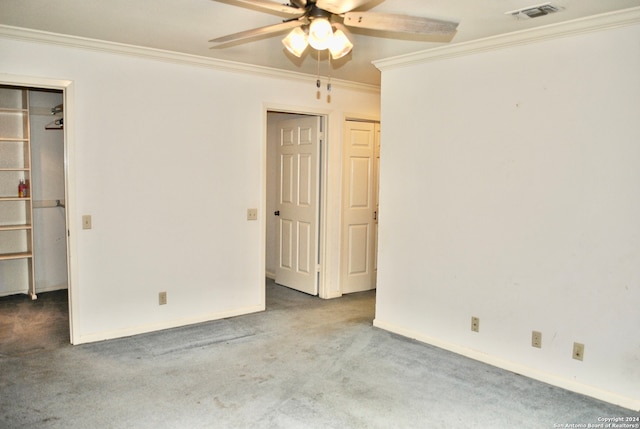 empty room featuring carpet flooring, ceiling fan, and ornamental molding