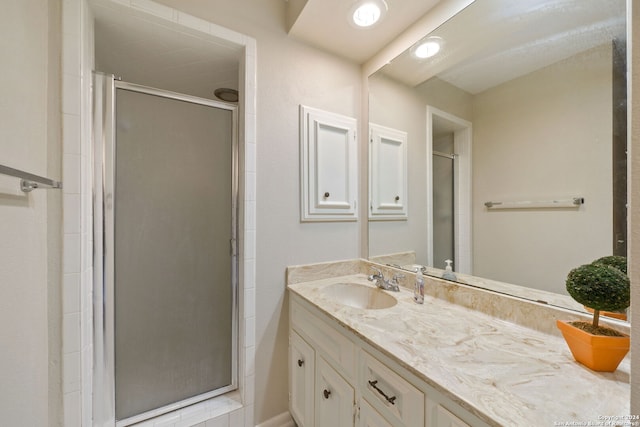 bathroom with vanity and walk in shower