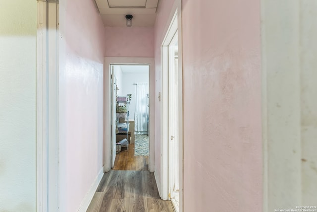 corridor with wood-type flooring