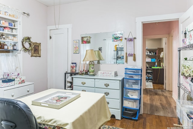 bedroom with dark hardwood / wood-style flooring