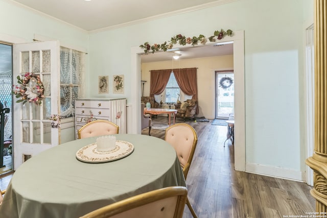 dining space featuring crown molding and hardwood / wood-style flooring