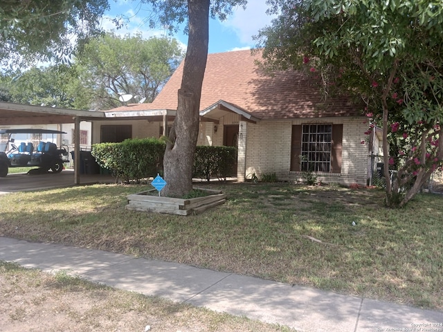 view of front of home with a front lawn and a carport