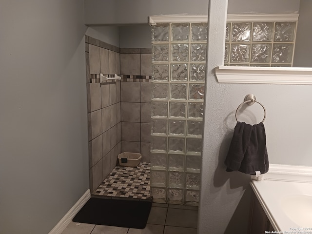 bathroom with vanity, tile patterned flooring, and a tile shower