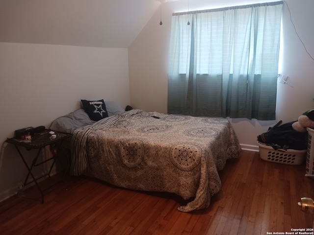 bedroom with lofted ceiling and hardwood / wood-style floors